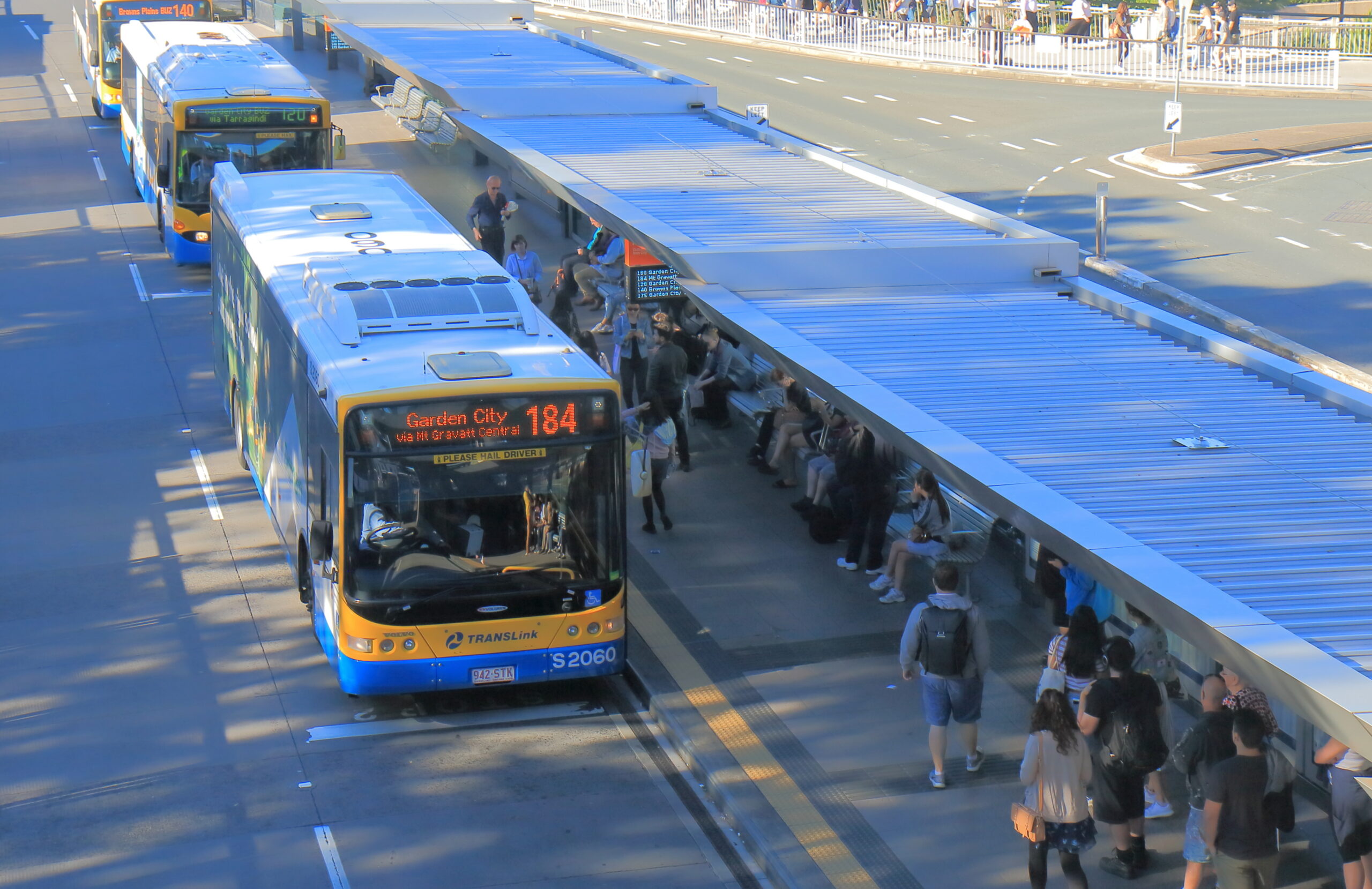 Modern bus shelters with professional public space furniture installation alongside durable school shelters in an Australian streetscape.