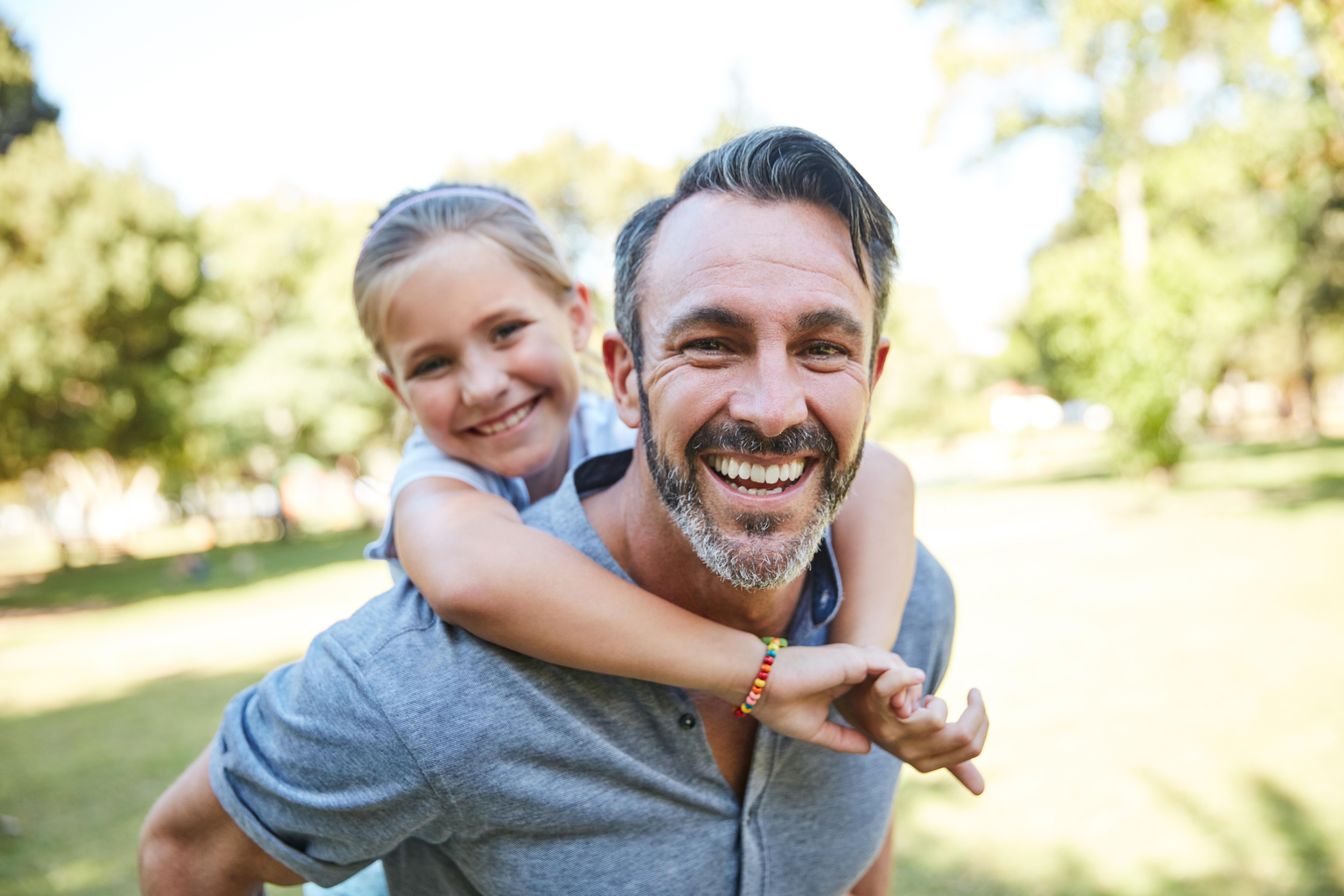 Confident man smiling with healthy teeth, representing orthodontics for adults, adult braces, and family orthodontic care.