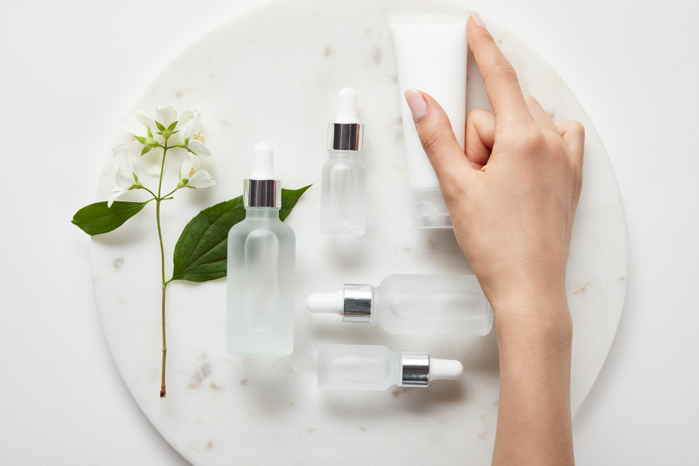 Australian woman using active skincare products, retinal cream and vitamin C serum in Australia as part of her seasonal skincare routine.