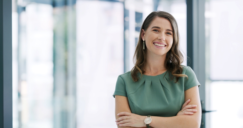 Adult professional smiling confidently at work while considering orthodontics for adults, affordable braces in Melbourne and Invisalign for professionals.